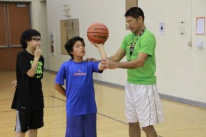 FCA Philippines coach Al Solis teaching a student at a basketball camp in the U.S.